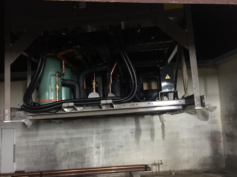 A Room With a Lot of Pipes Hanging From the Ceiling — Legit Air Conditioning in Garbutt, QLD