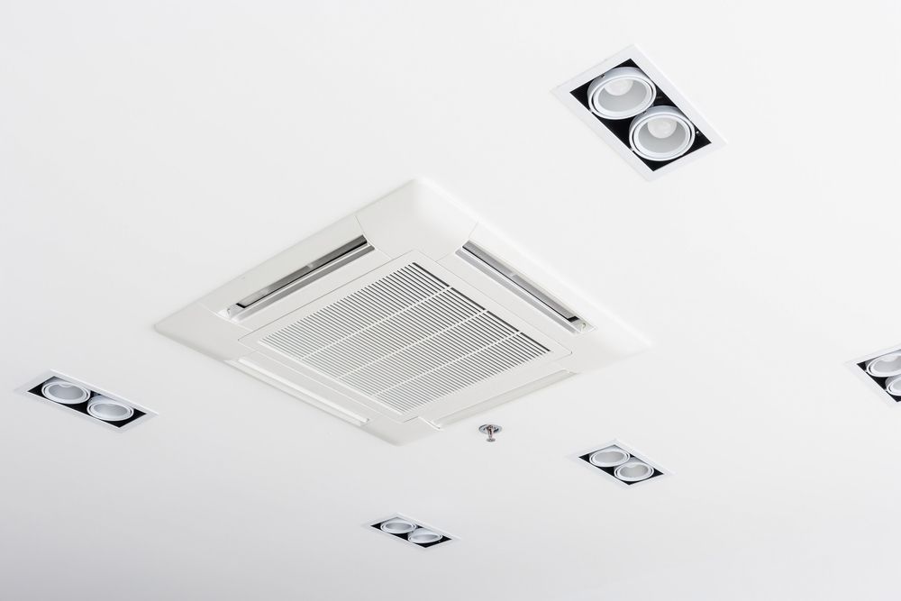 A Square Air Conditioner is Hanging From the Ceiling in a Room — Legit Air Conditioning in Garbutt, QLD
