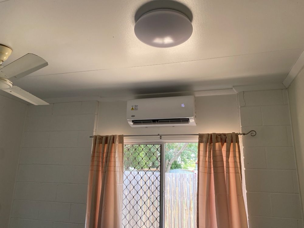 A Room With a Window , Ceiling Fan , and Air Conditioner — Legit Air Conditioning in Garbutt, QLD