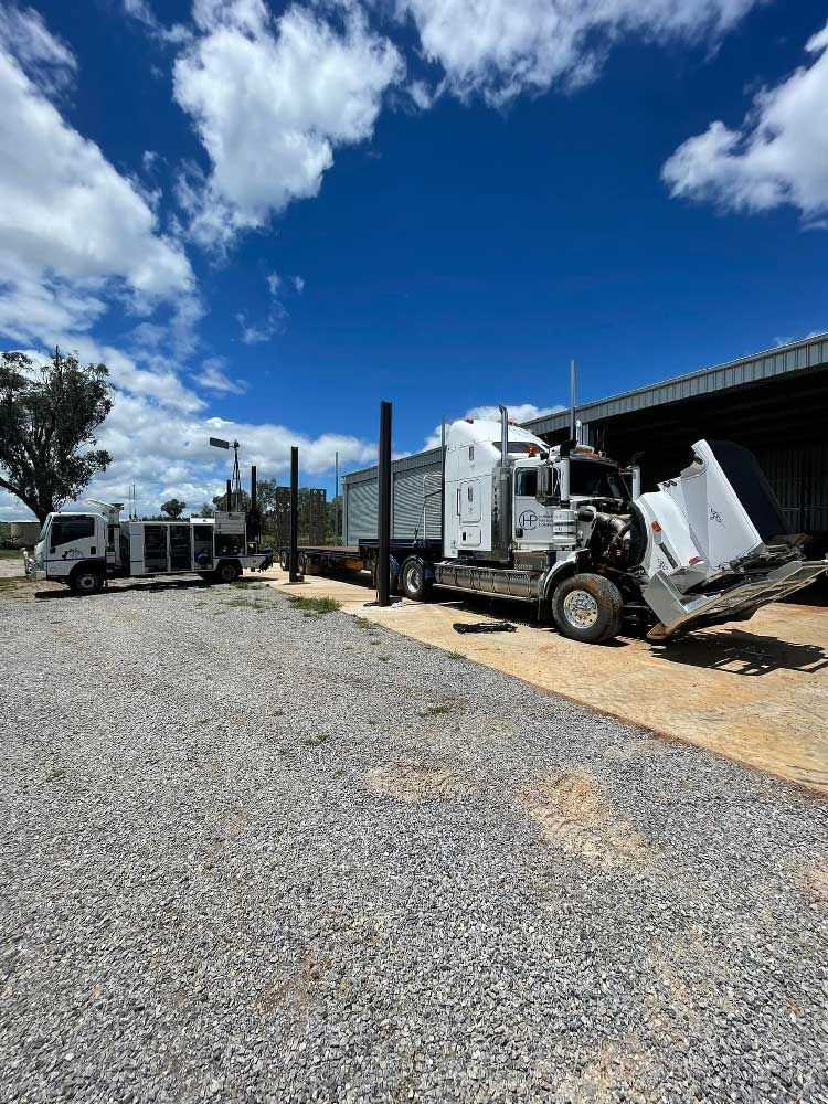 Large White Truck With Trailer is Parked in a Gravel Lot — Superior Diesel Maintenance in Westdale, NSW
