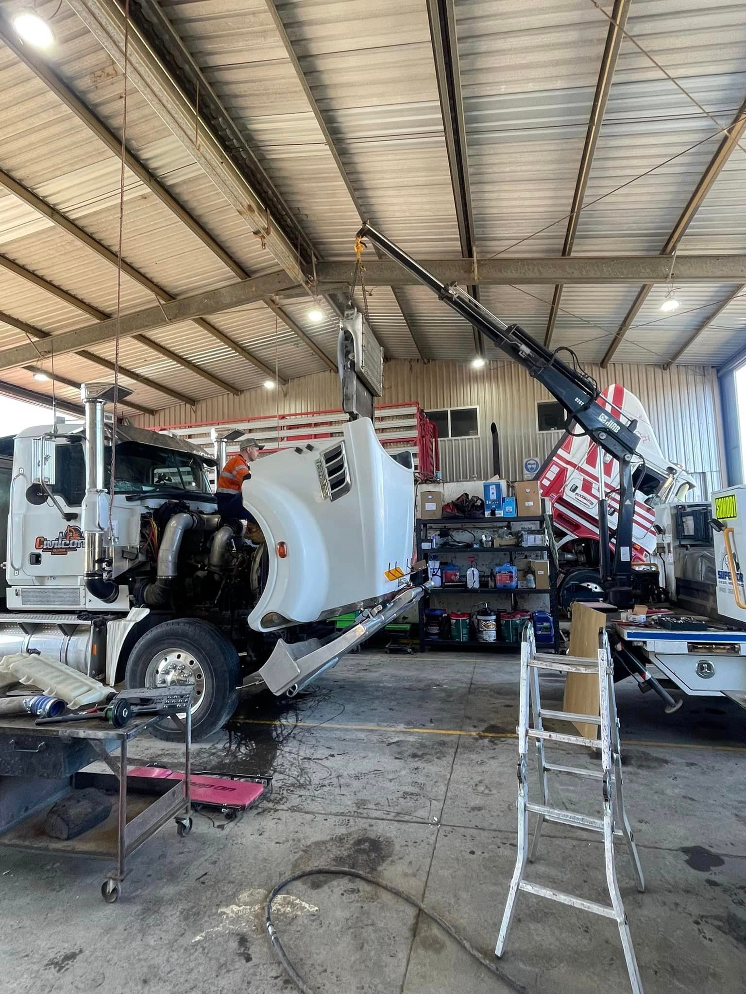 Mechanic Working Under a Truck — Superior Diesel Maintenance in Westdale, NSW