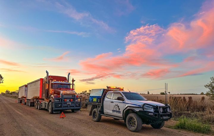 Red Truck getting roadside assistance with sunset in the background — Superior Diesel Maintenance in Westdale, NSW