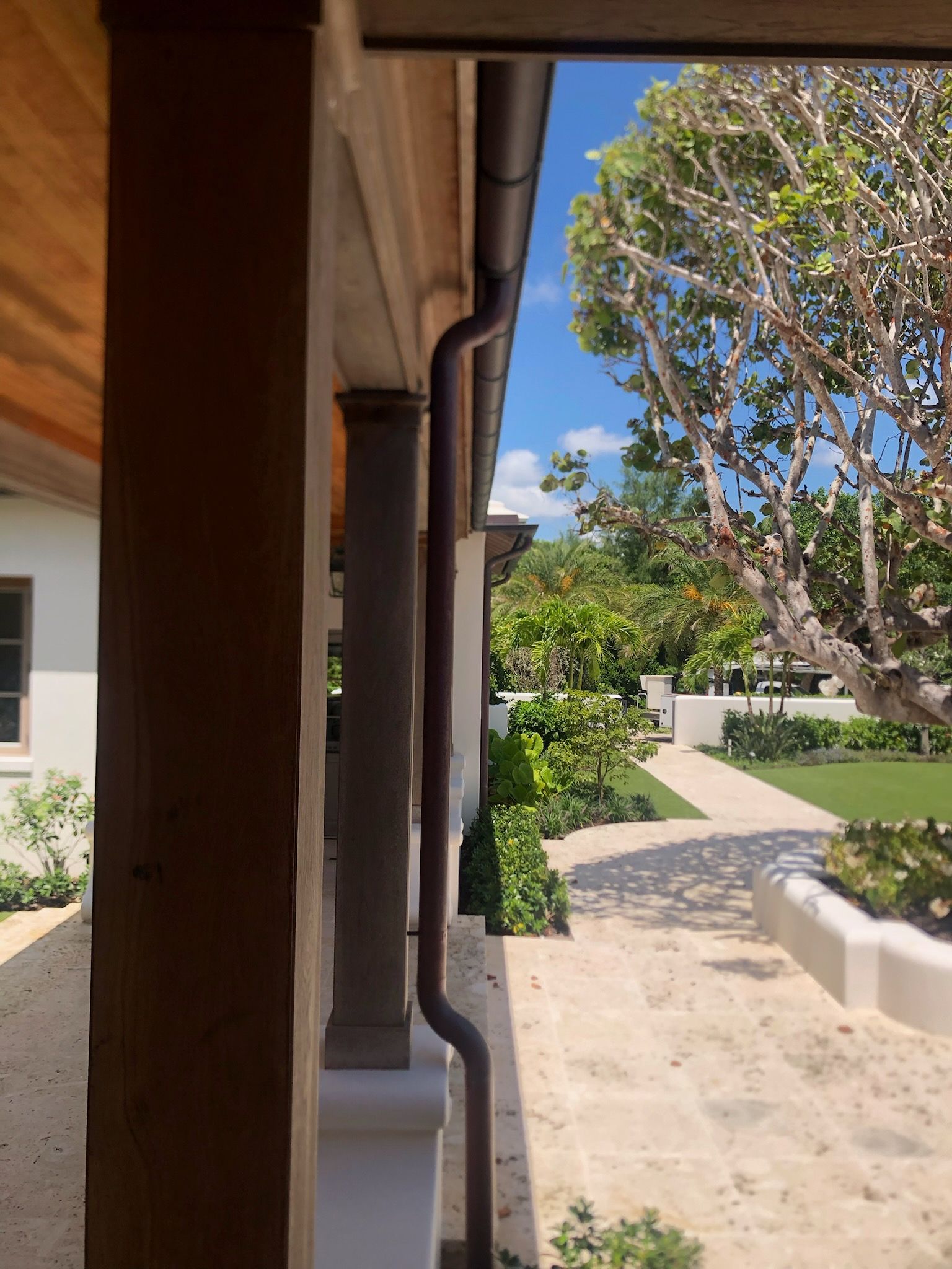 Black metal roof with matching gutters and downspouts, angled shot.