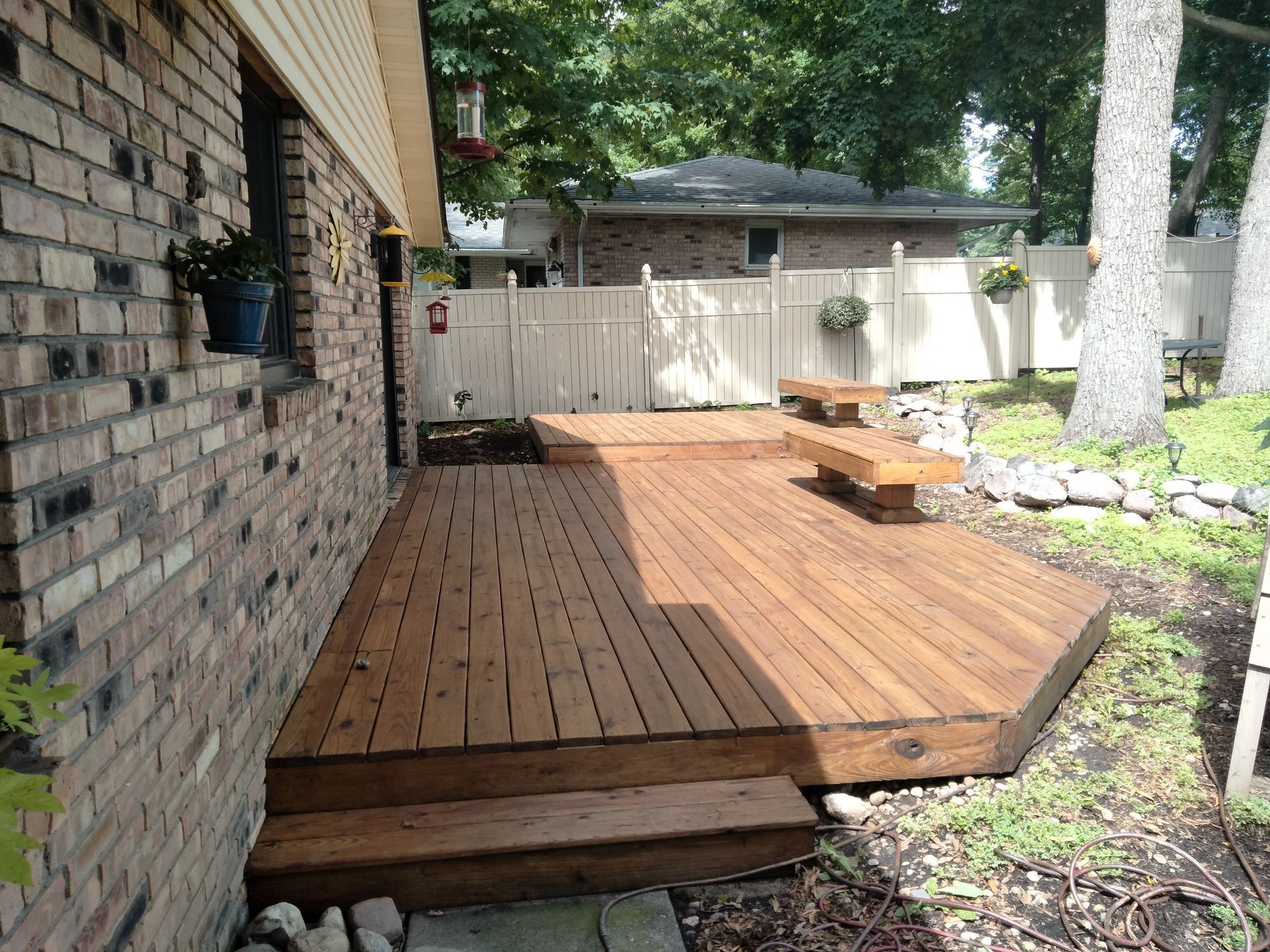 A brick house with a wooden deck in front of it