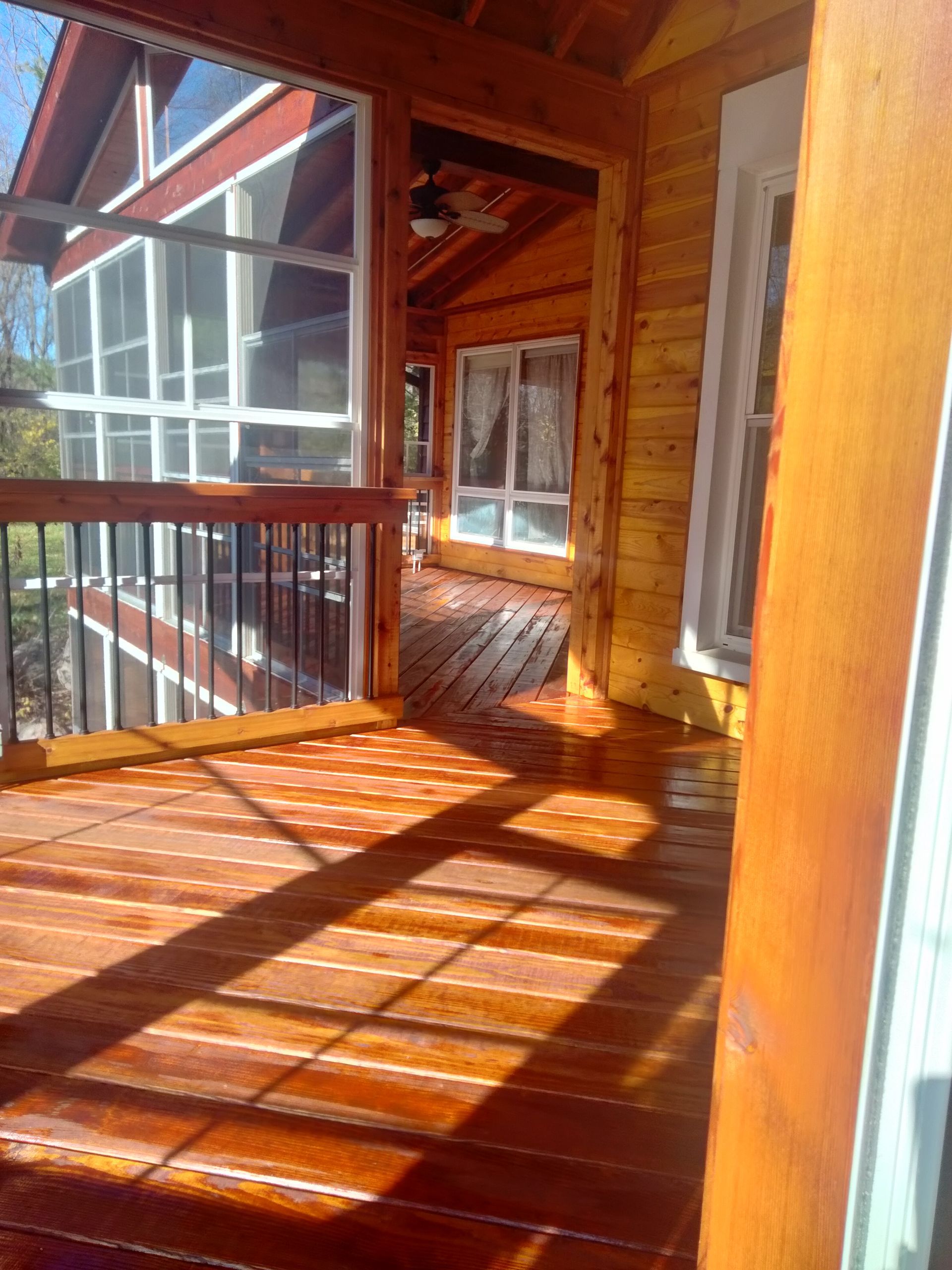 A screened in porch with a lot of windows