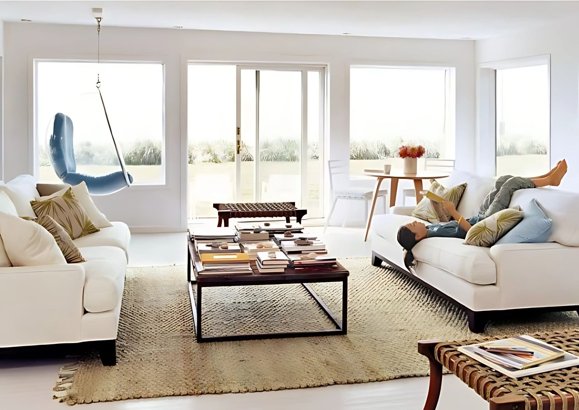 A living room with two white couches and a coffee table