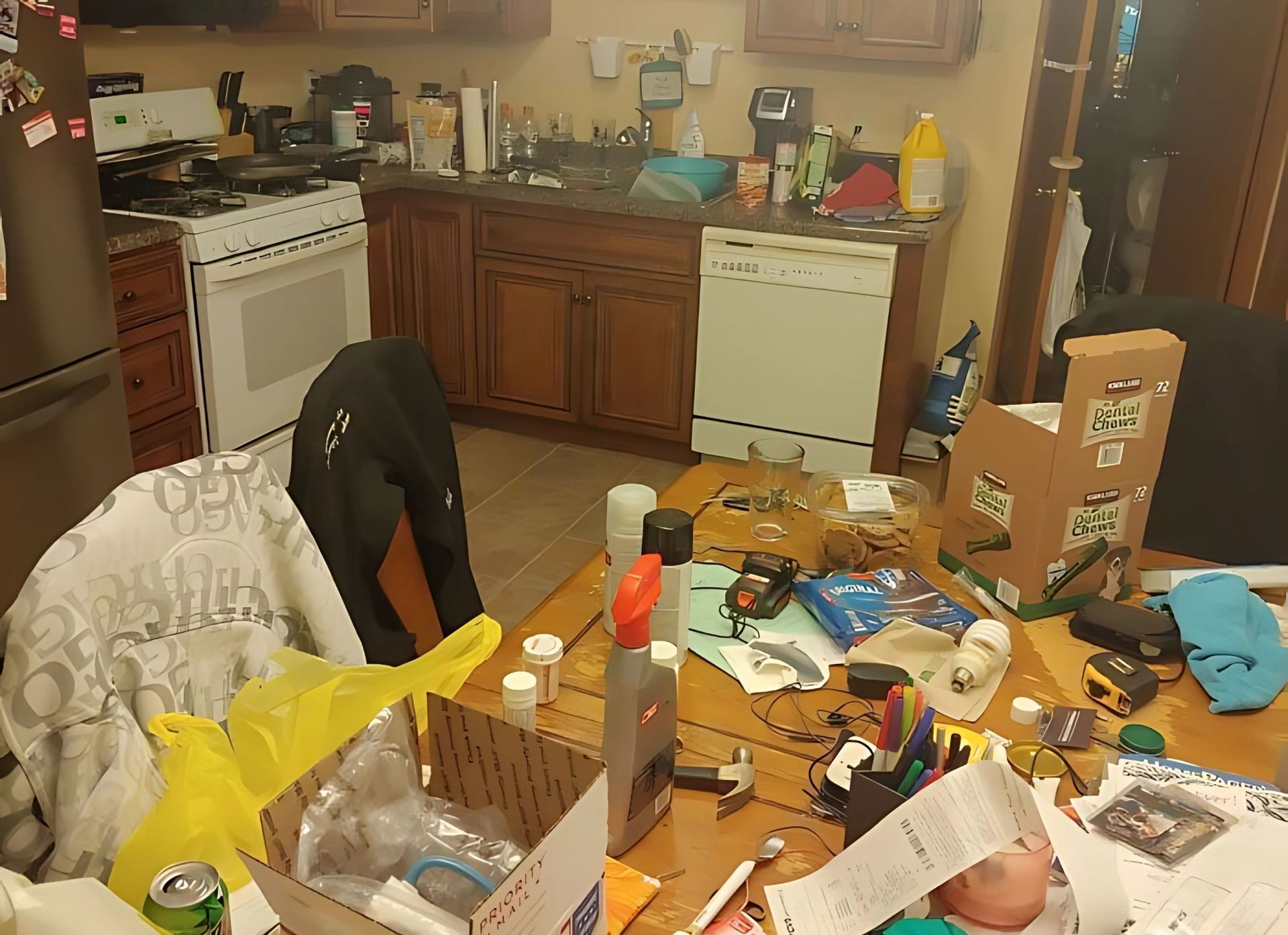 A messy kitchen with a stove and dishwasher