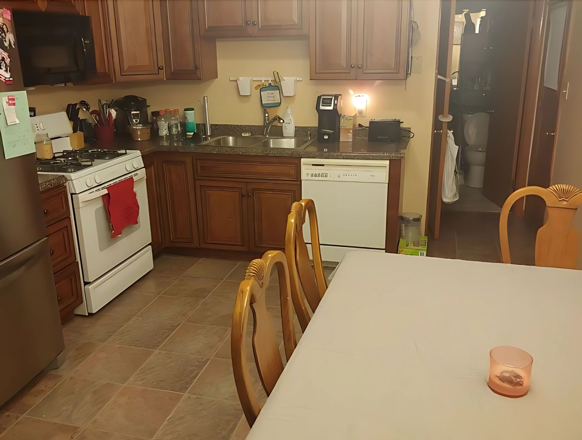 A kitchen with a table and chairs and a stove
