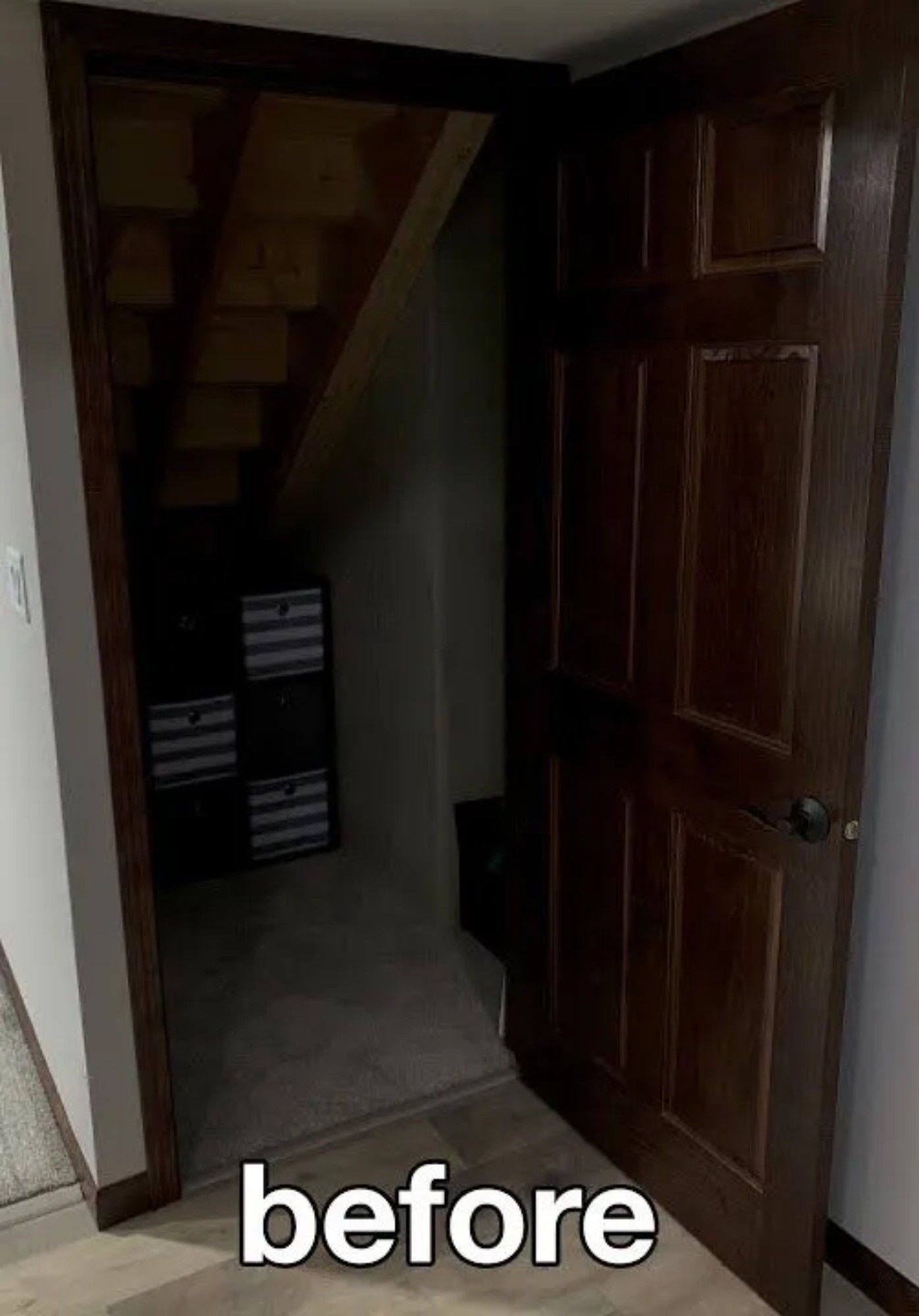 A before picture of a closet with stairs and a door.