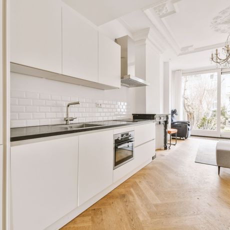 GetReadytoList | A kitchen with white cabinets and a wooden floor
