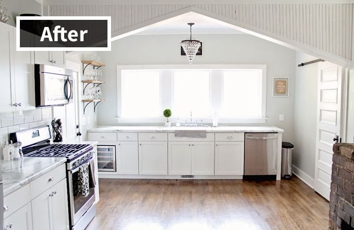 A kitchen with white cabinets , stainless steel appliances , and hardwood floors.