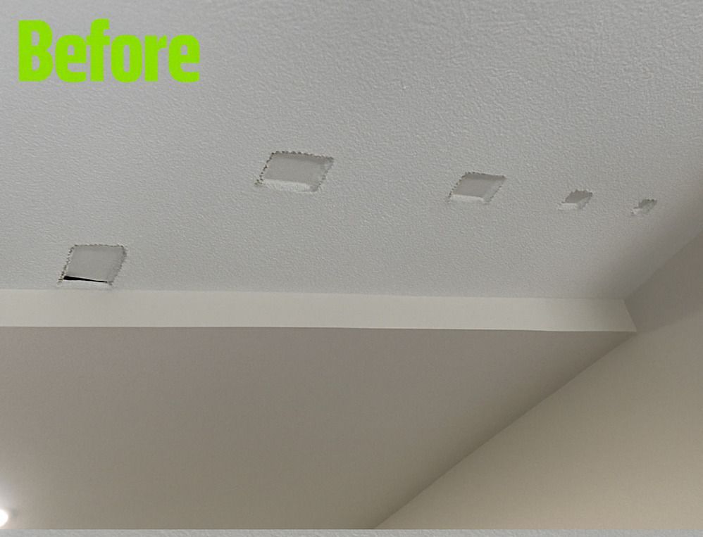 A before picture of a ceiling with holes in it.