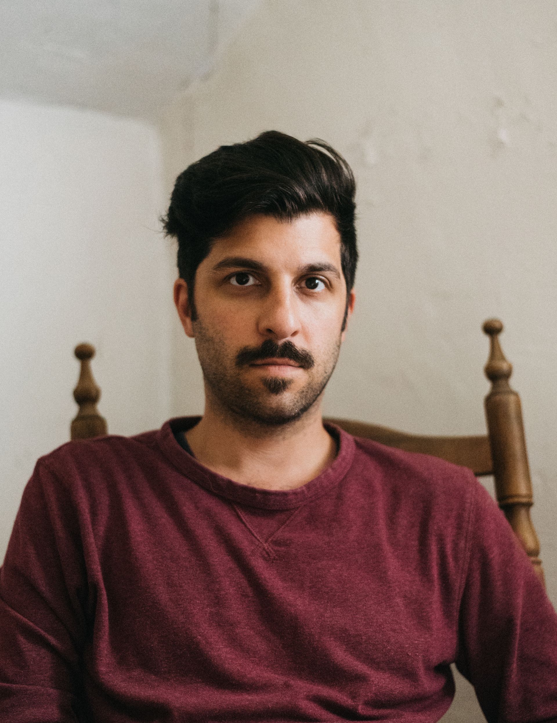 Photo of Adam Paolozza sitting on a chair