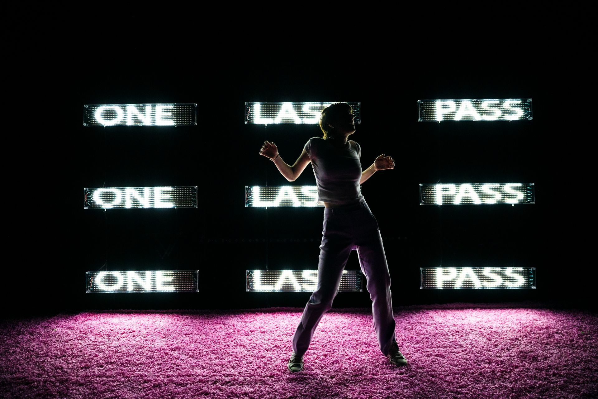 Silhouette of person dancing with neon 