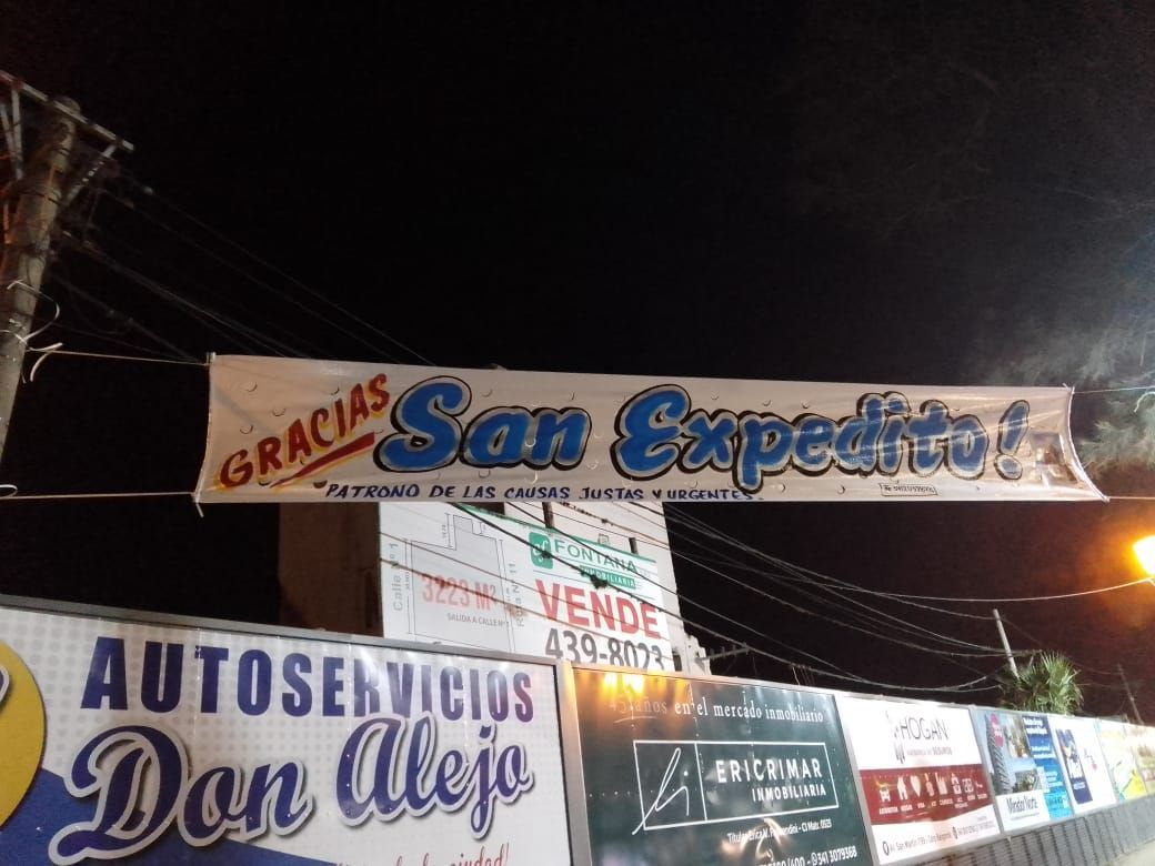 A sign for san expedito hangs over a sign for autoservicios don aleja