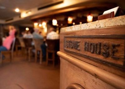 A wooden box with the word stone house on it in a restaurant.