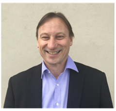 A man in a suit and smiles for the camera. Warren Meyer