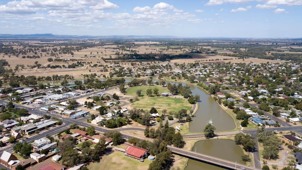 An Aerial View Of A Small Town With A Bridge Over A River — Nudges Plumbing In Forbes, NSW