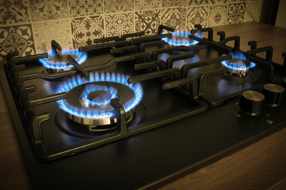 A Close Up Of A Gas Stove With Flames Coming Out Of It — Nudges Plumbing In Dubbo, NSW