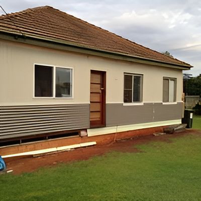 A House With A Brown Roof Under Plumbing Construction — Nudges Plumbing In Dubbo, NSW
