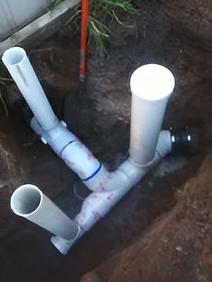 A Bunch Of White Pipes Are Laying In The Dirt — Nudges Plumbing In Narromine, NSW