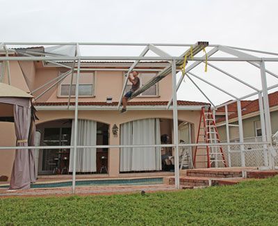 a man wearing a mask is standing on a ladder