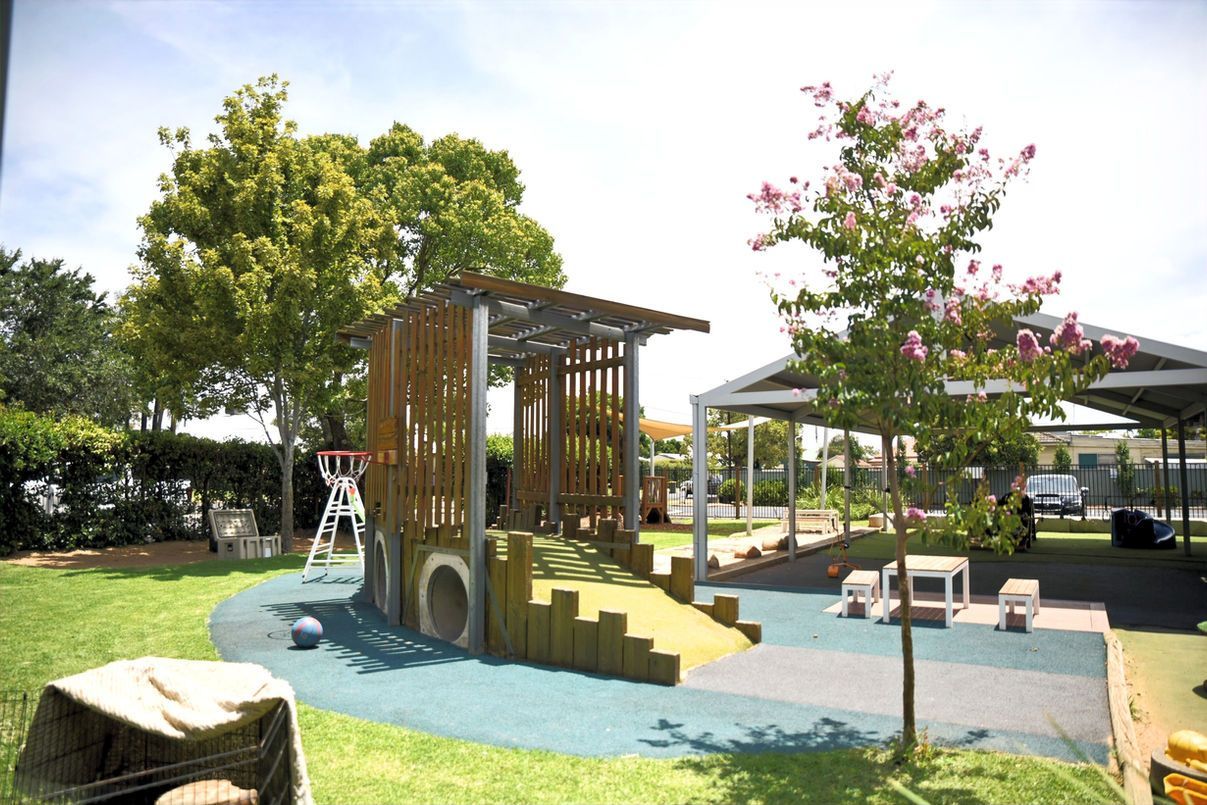 A playground with a tree in the middle of it