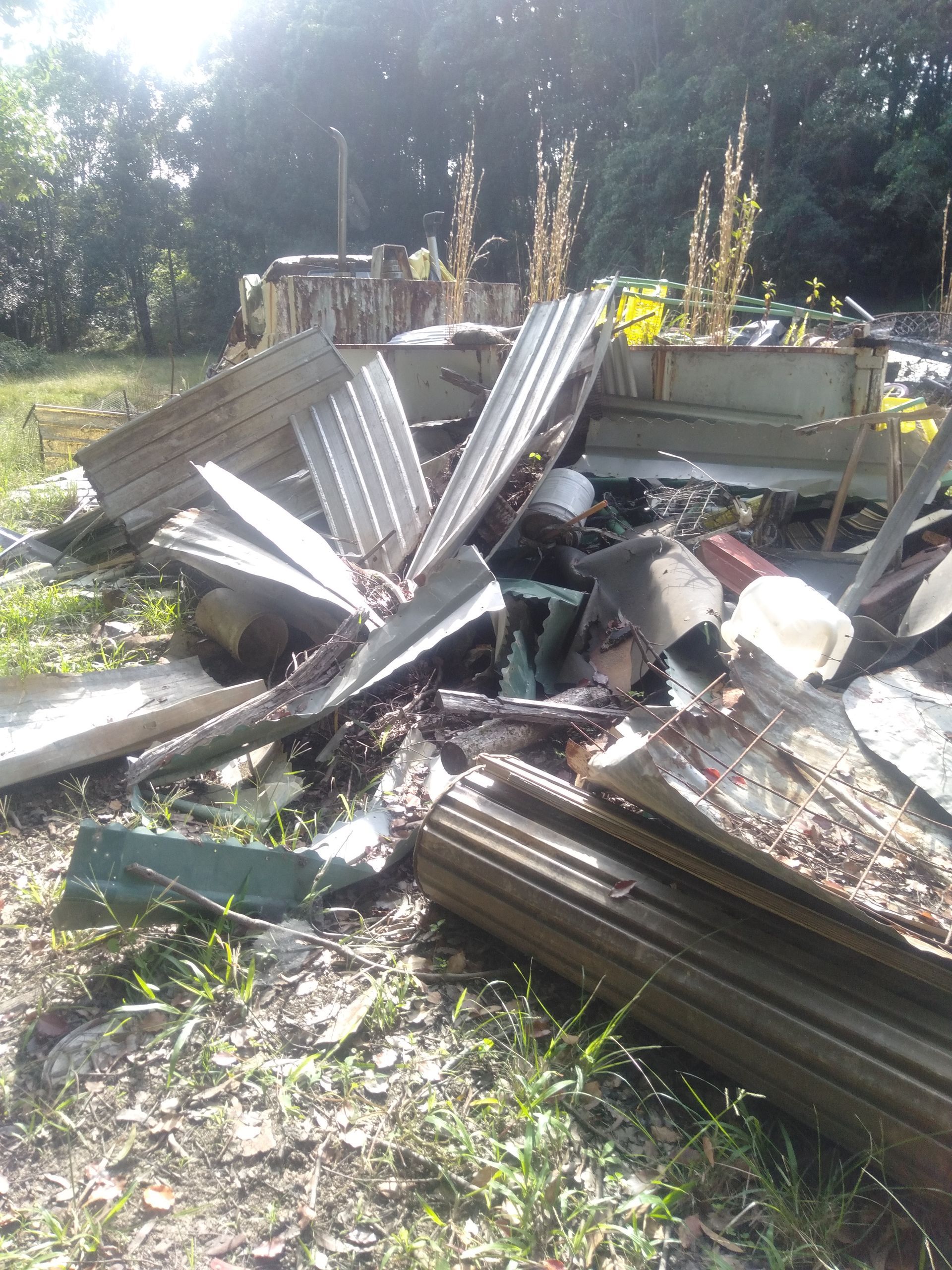 A Pile Of Junk Is Laying On The Ground In A Field — Tweed Byron Recycling In Tweed Heads, NSW