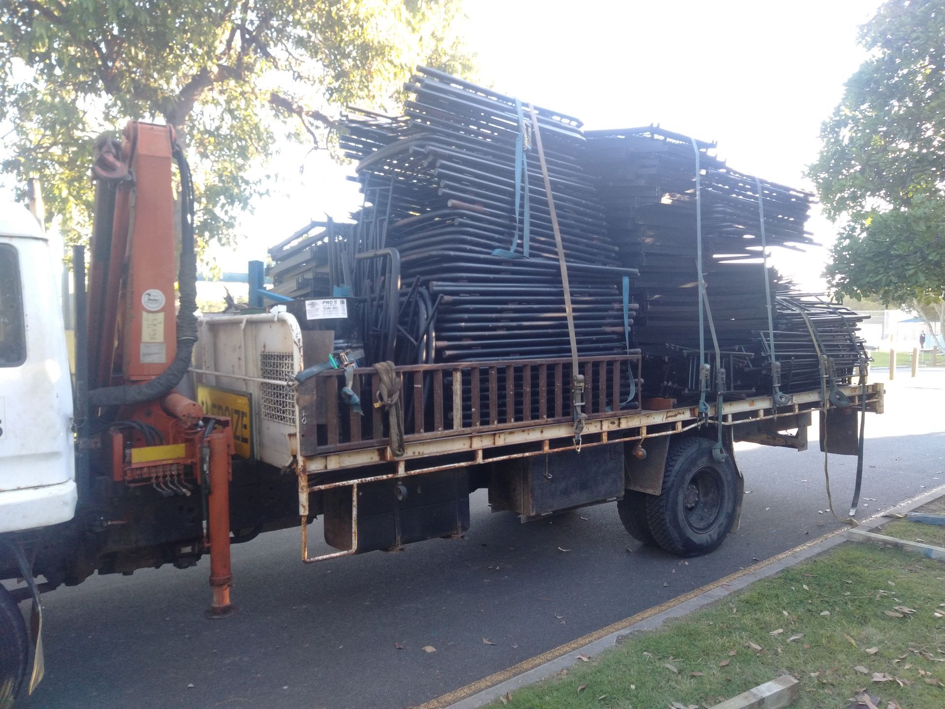 A Truck With A Crane On The Back Is Loaded With Scaffolding — Tweed Byron Recycling In Tweed Heads, NSW