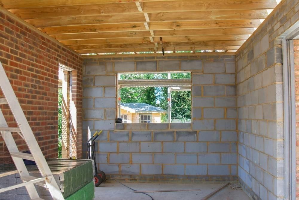 A room with brick walls and a window with a wooden ceiling.