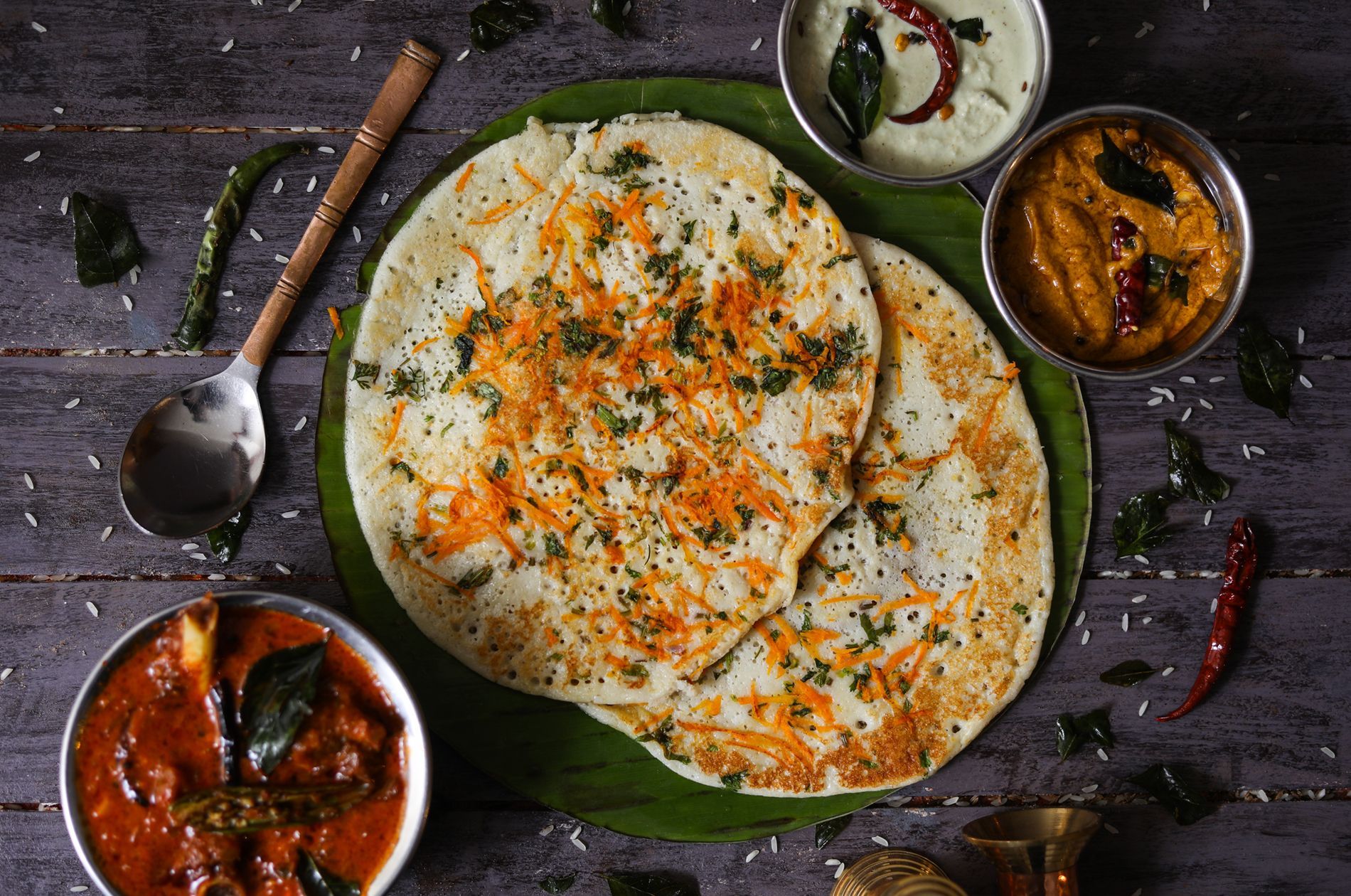 Traditional thali at a south indian restaurant featuring rice, spicy curries, fried fish, and seasonal vegetables served with authentic flavours.