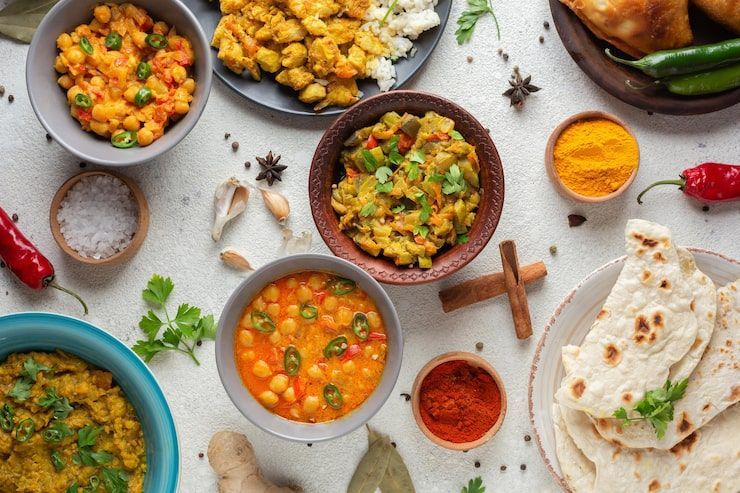 Indian curry spread with naan and spices.