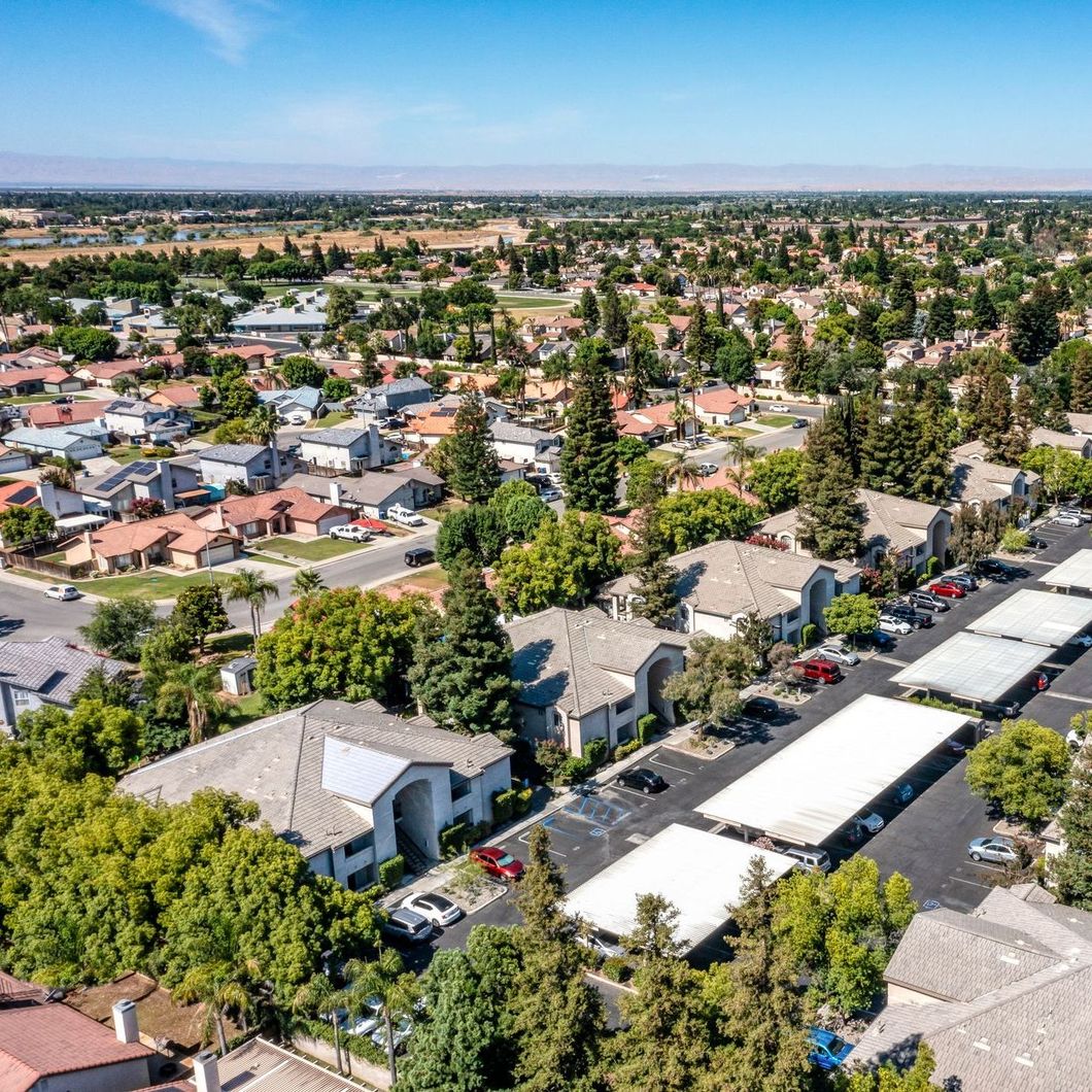 An aerial view of a residential area with lots of trees and houses.