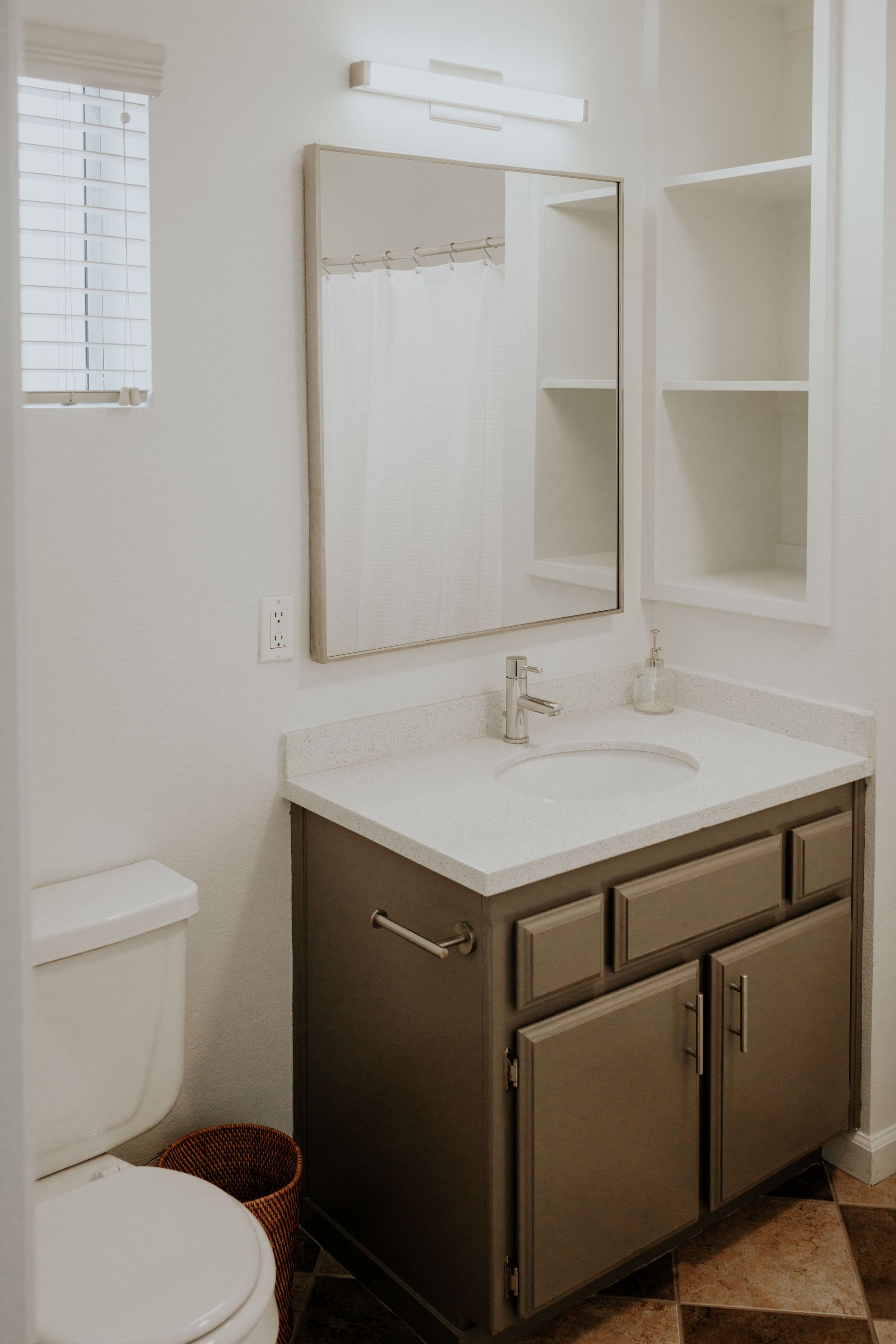 A bathroom with a tub , toilet , sink and mirror.