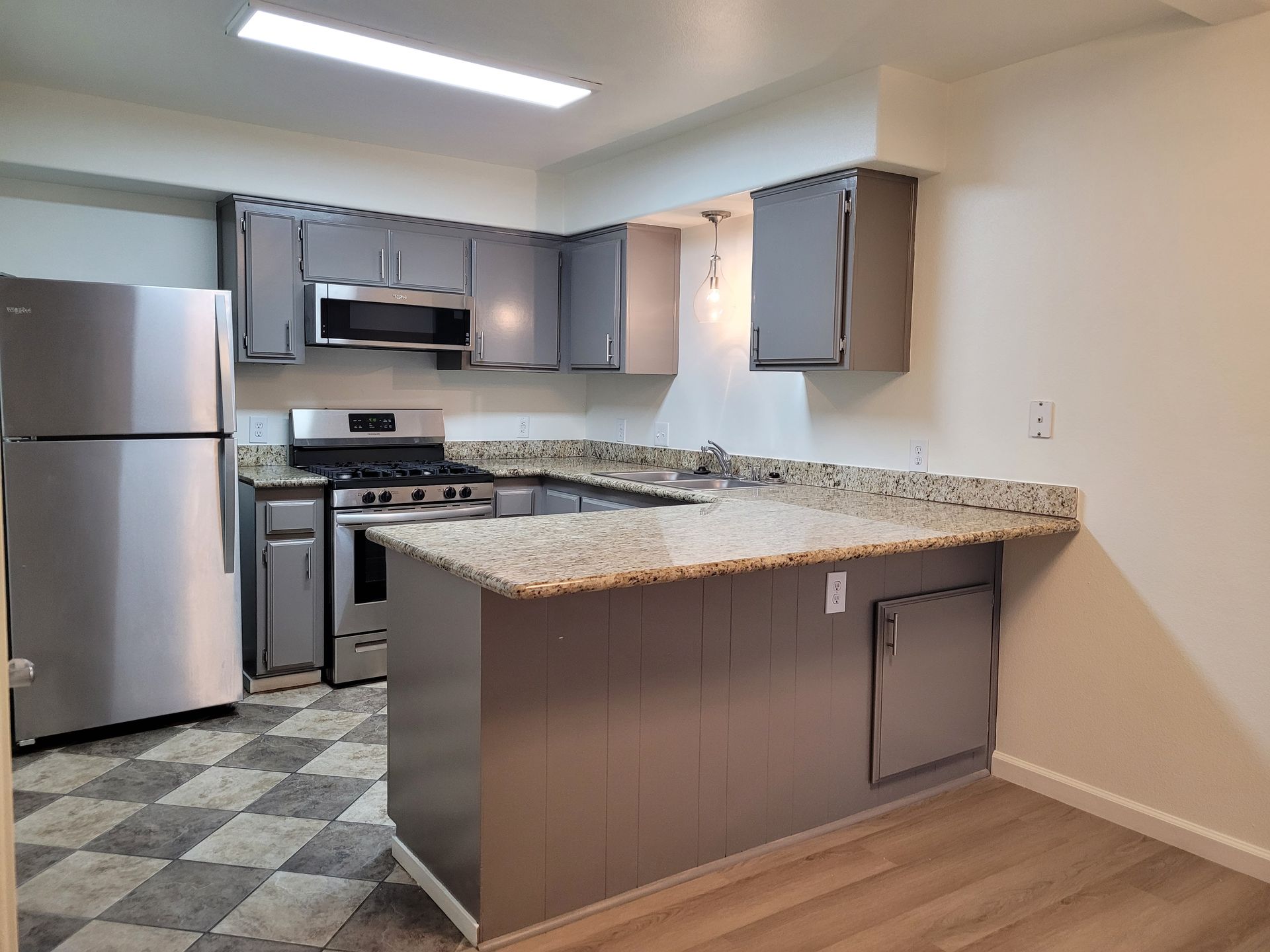 A kitchen with stainless steel appliances and granite counter tops