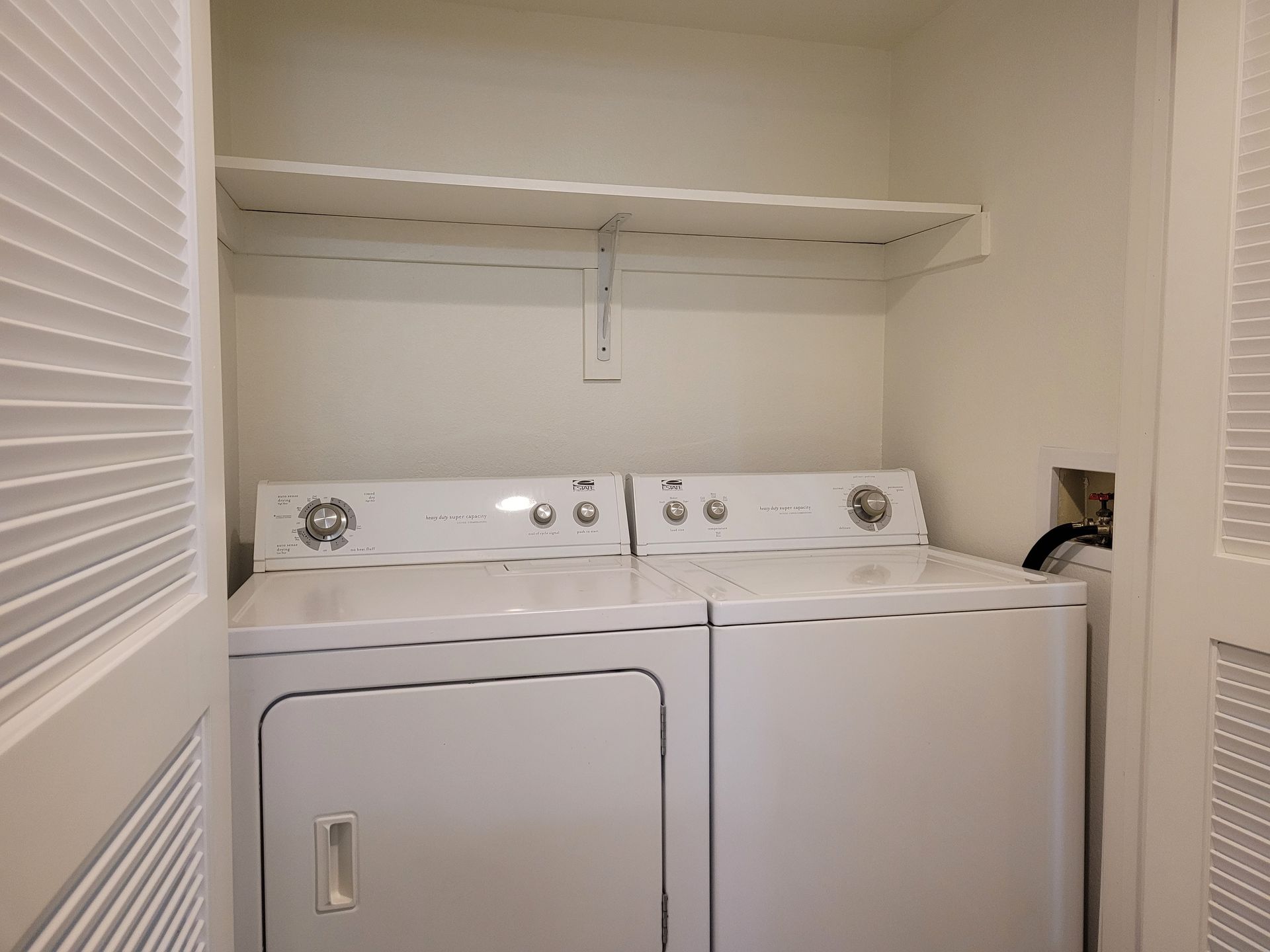 A laundry room with a washer and dryer in it.