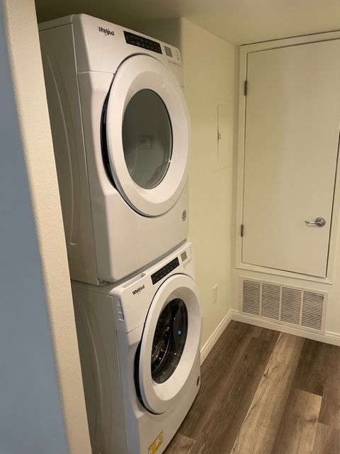 A washer and dryer are stacked on top of each other in a laundry room.