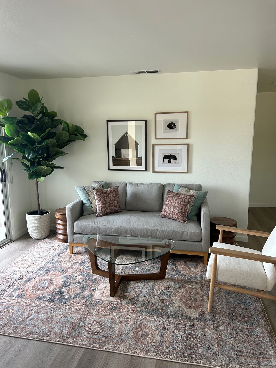 A kitchen with stainless steel appliances and gray cabinets.