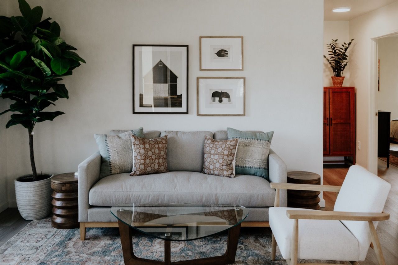 A kitchen with stainless steel appliances and gray cabinets.