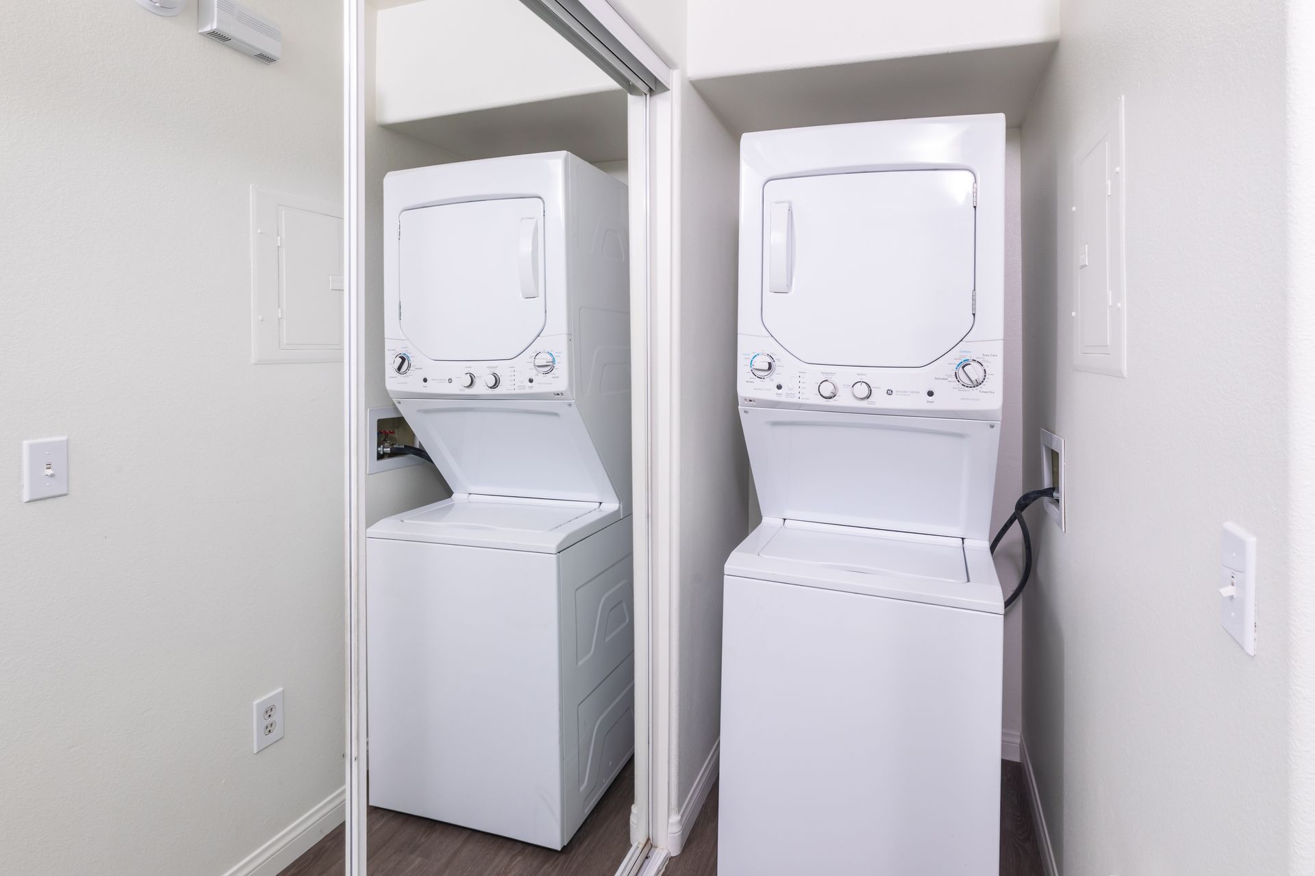 A washer and dryer are stacked on top of each other in a laundry room.