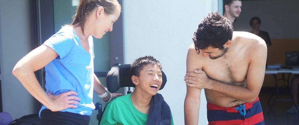 KEEN Volunteers with Athlete in wheelchair at pool