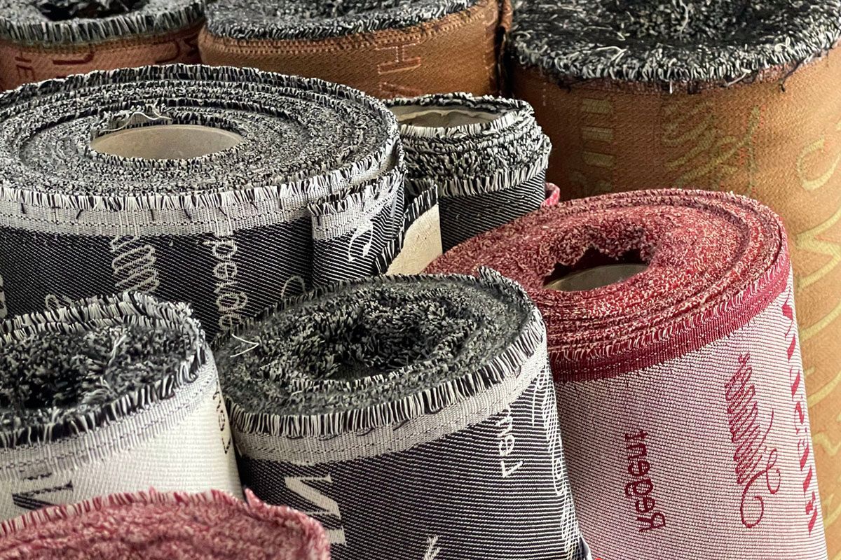 Ein Bündel Stoffrollen ist übereinander gestapelt.