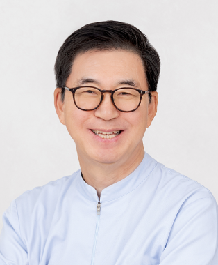 A smiling Asian man in a white lab coat, likely a healthcare professional.