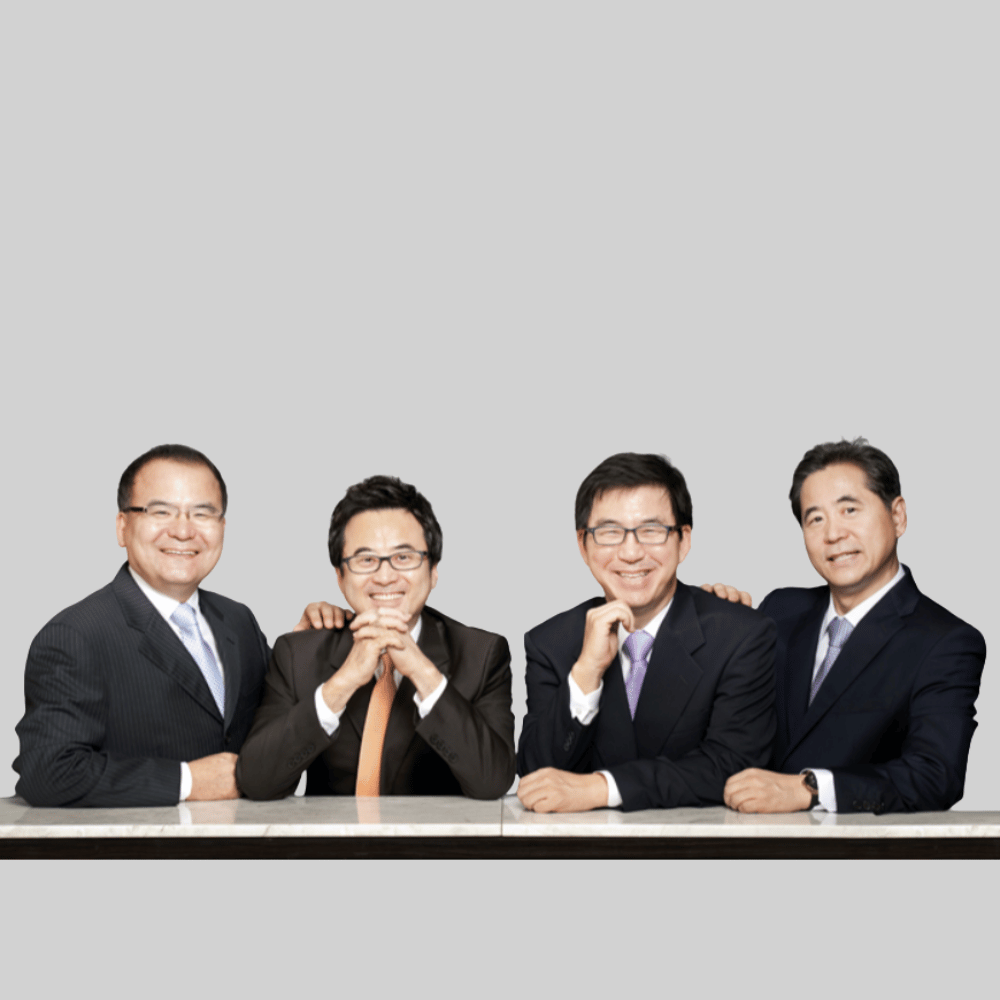 Man in a suit and glasses speaks at a podium with a microphone.