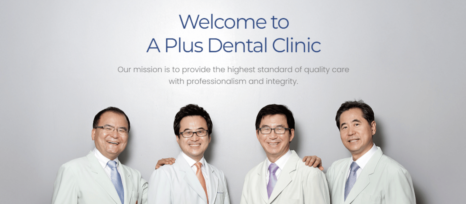 Group of Korean doctors in white coats smiling, posing for a photo.