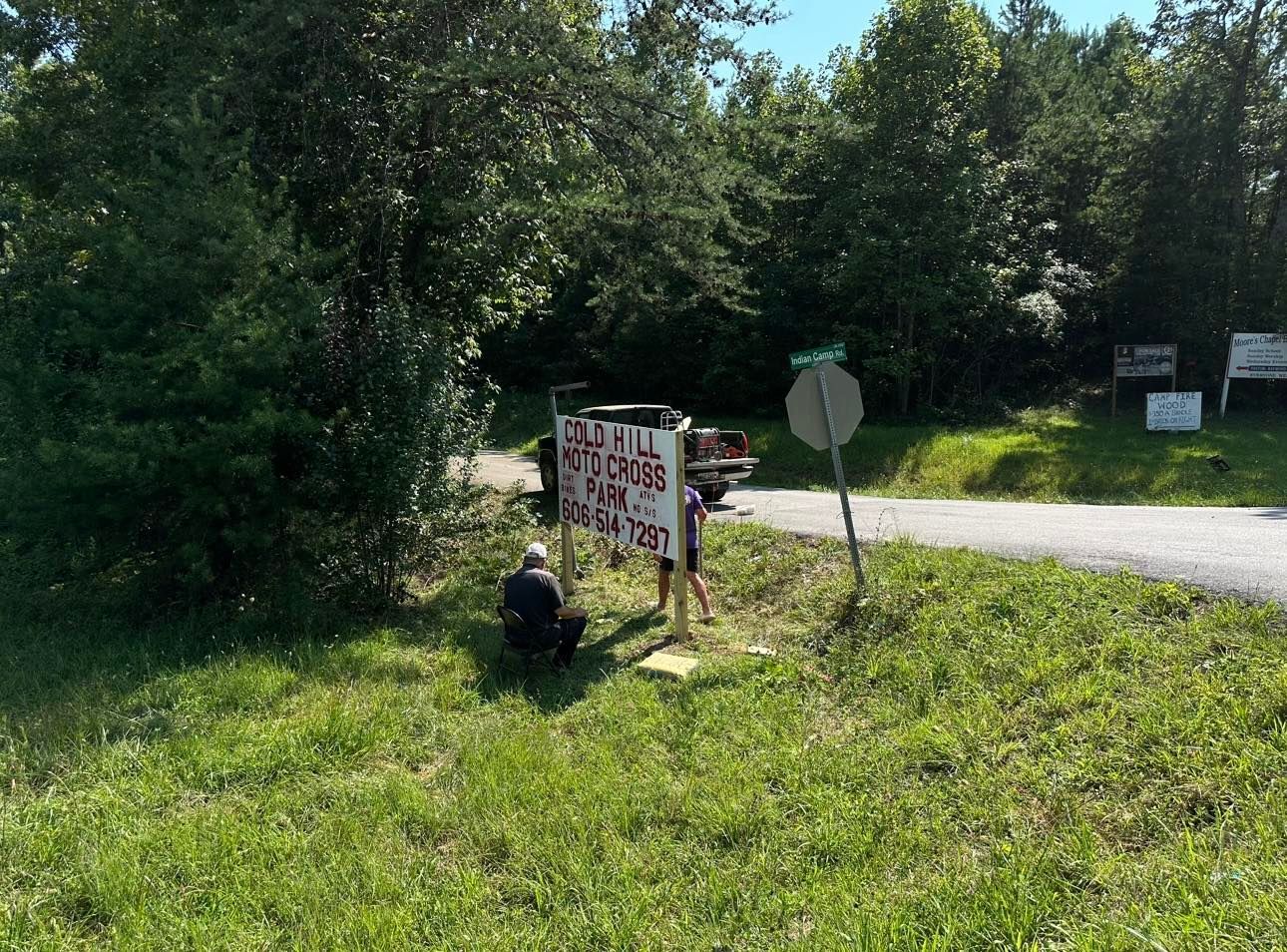 Two people work on a sign for 