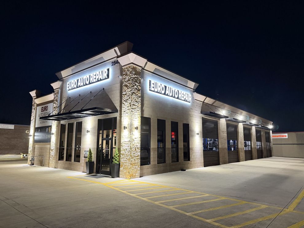 Euro Auto Repair building lit up at night. Signage is visible | Euro Auto Repair