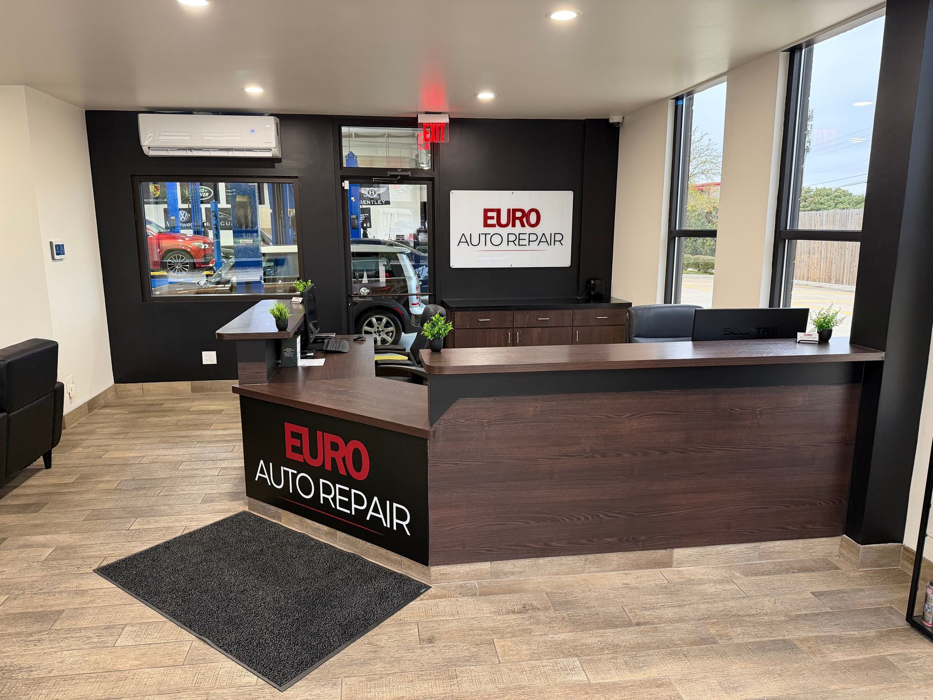 Reception area of Euro Auto Repair with desk, logo, and waiting area | Euro Auto Repair