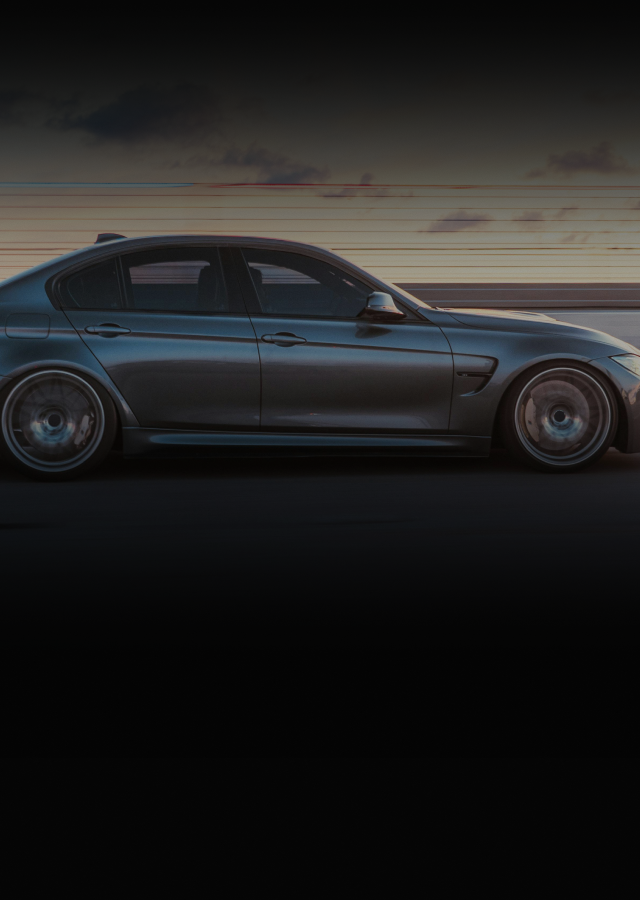 Silver sedan speeding down a road at dusk | Euro Auto Repair