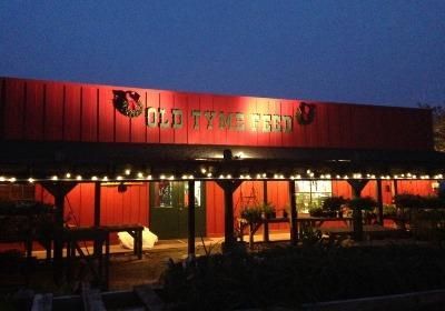 A red building that says old tyme feed on it